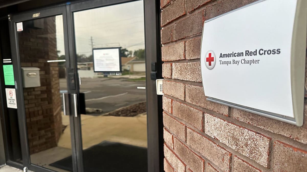 Red Cross volunteers helping displaced families in emergency shelter after Washington wildfires