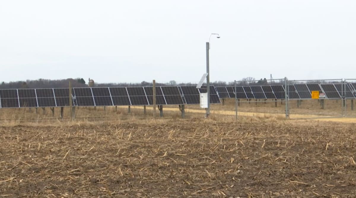 Rows of solar panels at Wisconsin's Darien Solar Energy Center gleaming under blue sky