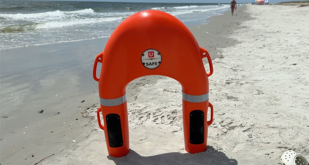 Remote-controlled rescue buoy speeding through ocean water toward distressed swimmer off North Carolina coast