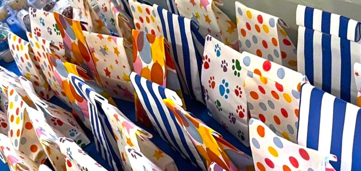 Volunteers preparing birthday party supplies and gift bags for children in need