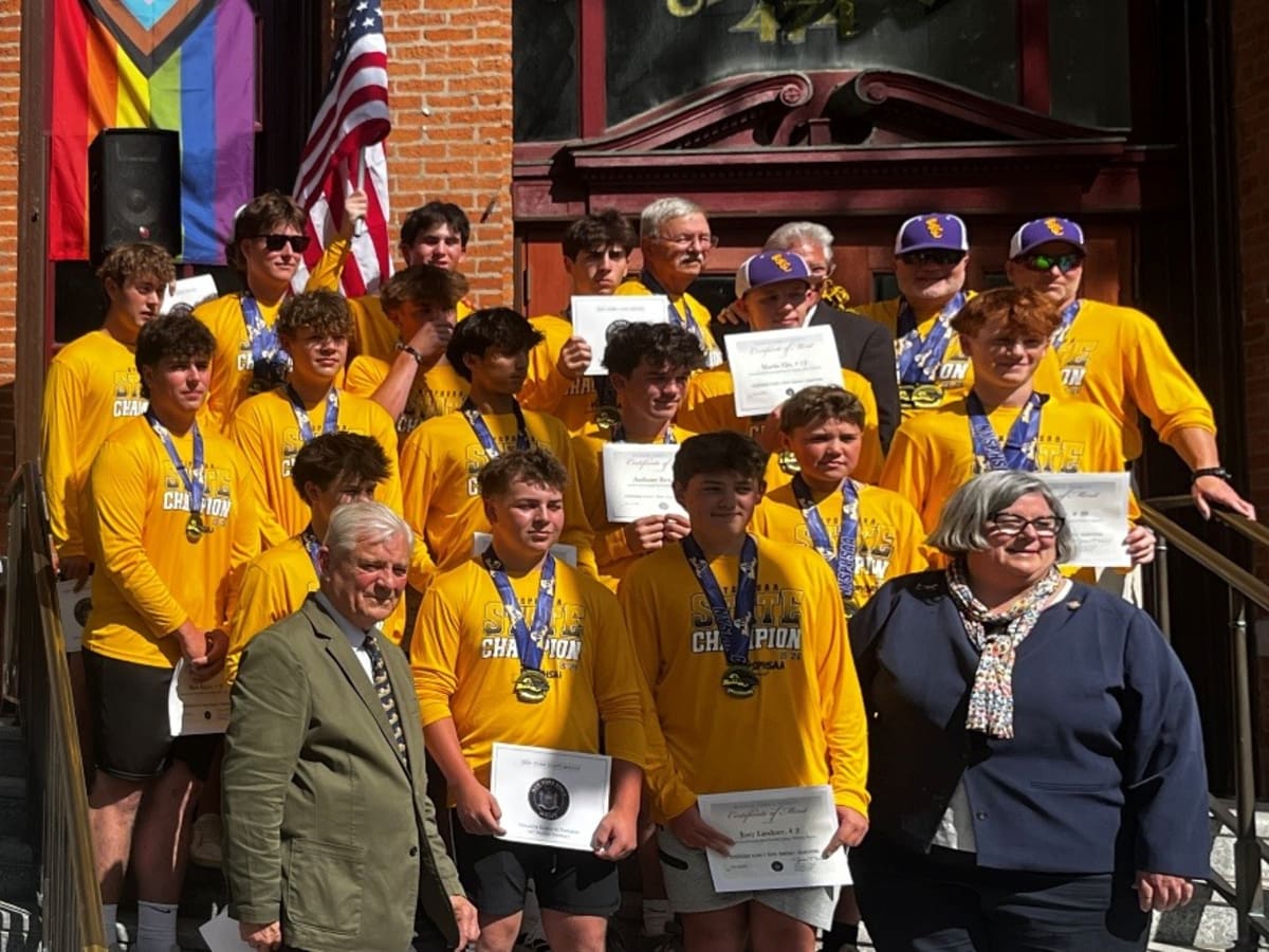 Spa Catholic baseball players celebrating on City Hall steps with coaches and local officials