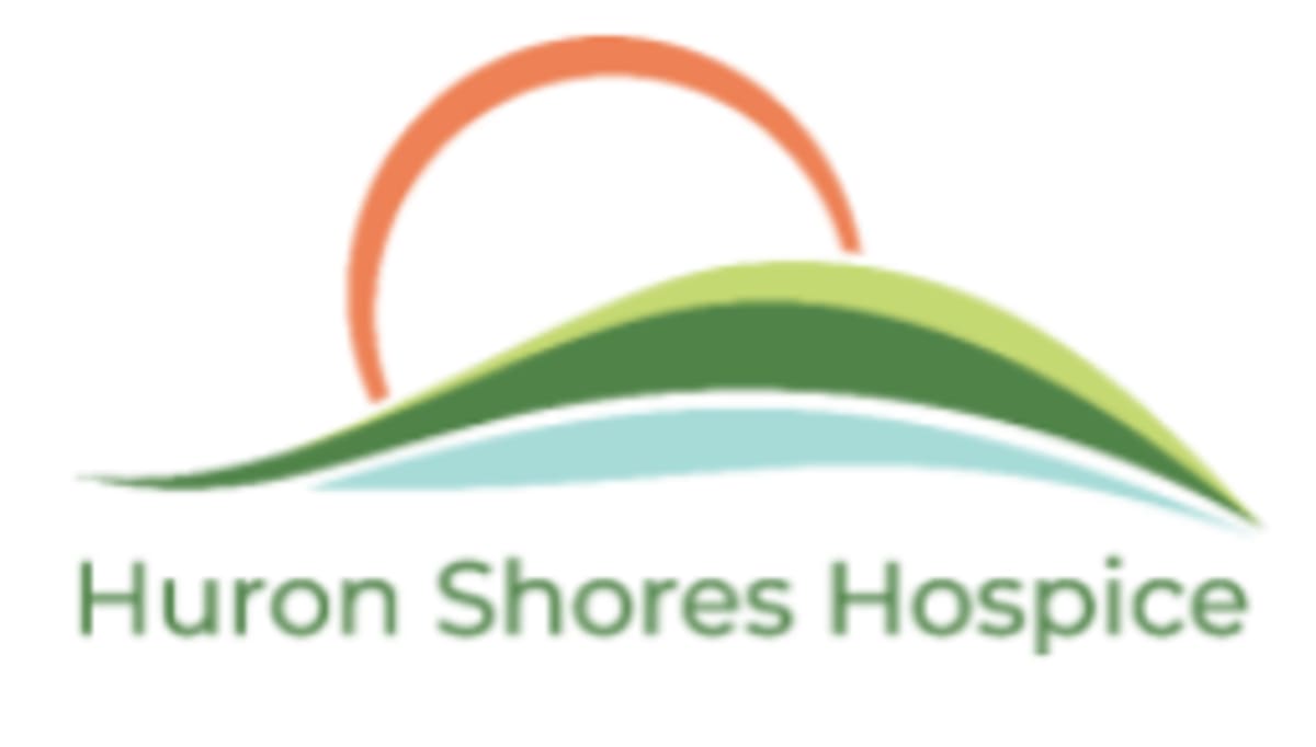 Peaceful hospice room with comfortable seating showing compassionate end-of-life care environment