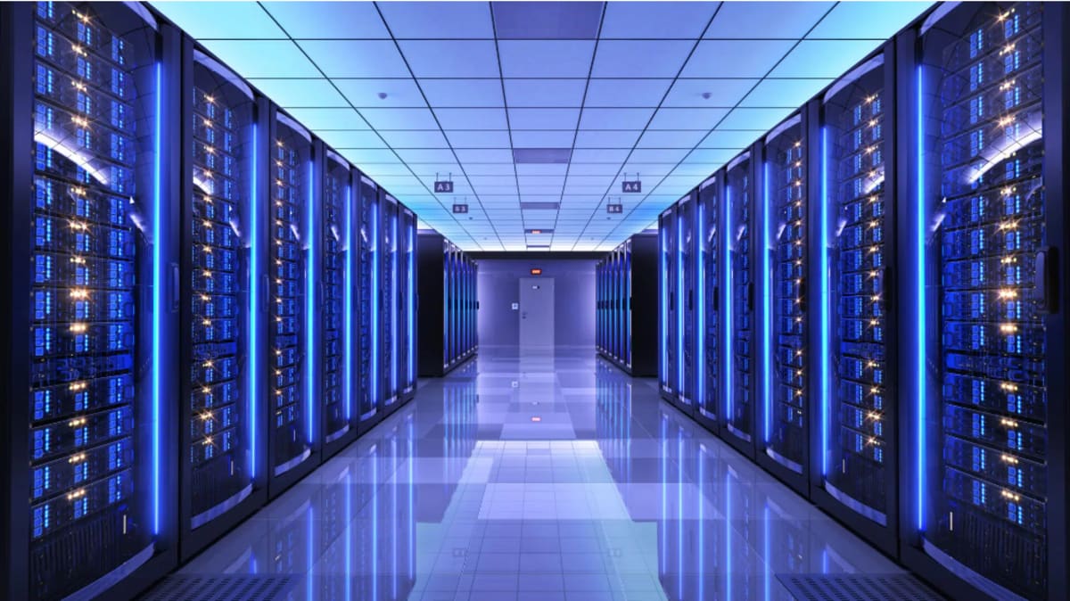 Modern data center facility exterior with mountains in background representing Norway's new AI hub