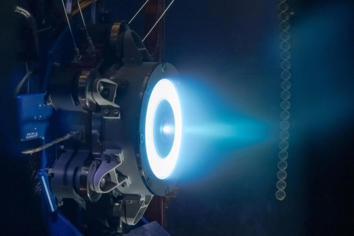 NASA electric propulsion thruster glowing during high-temperature testing at research facility