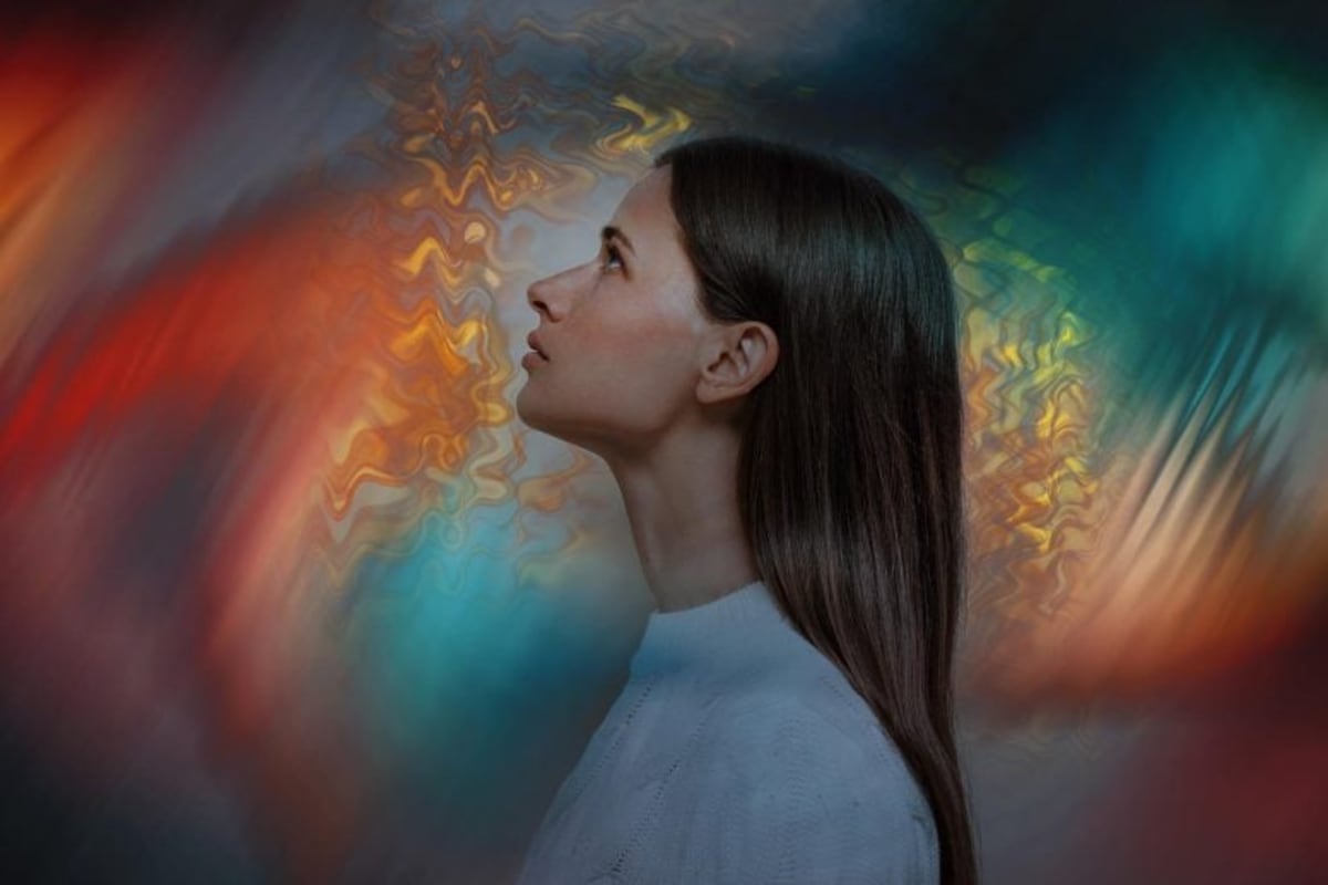 Medical researcher analyzing brain wave patterns on computer screens showing EEG signals