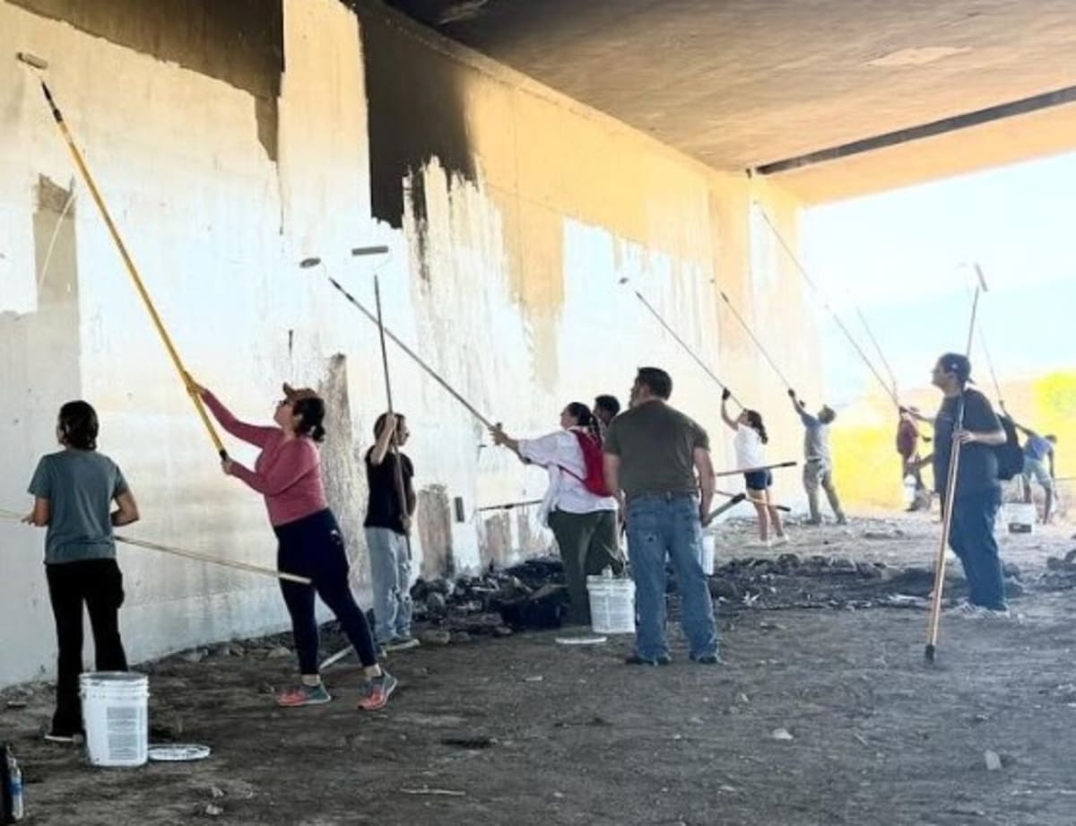 ** Volunteers cleaning debris from Santa Clara River during community environmental restoration event