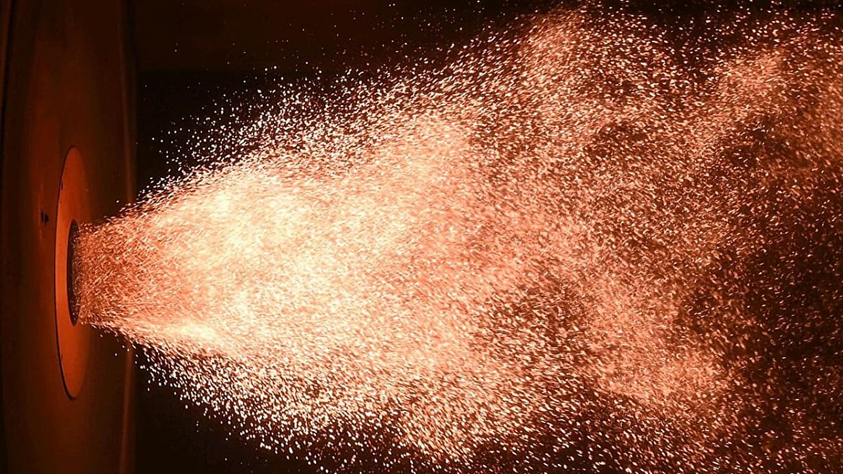 Orange flame from burning iron powder in laboratory demonstration at Karlsruhe Institute