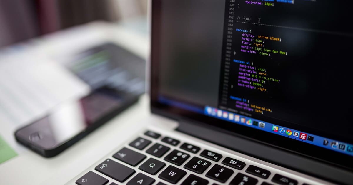 Computer screen showing AI-generated scientific code with neural network visualization in background