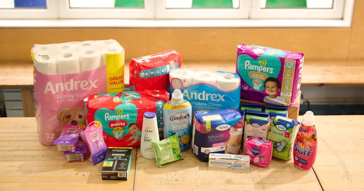 ** Shelves stocked with hygiene products including soap bottles and toothpaste tubes ready for charity distribution
