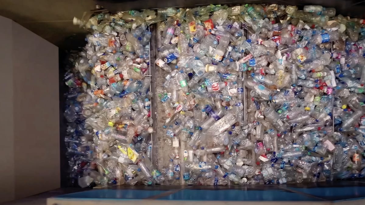 Modern plastic sorting facility in Sharjah with recycling machinery processing containers and bottles