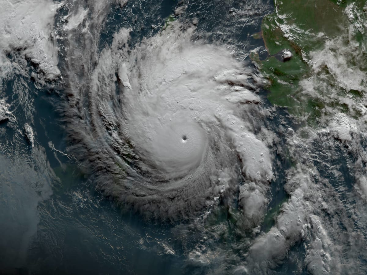 Satellite view of a powerful hurricane with clearly defined eye wall approaching coastline