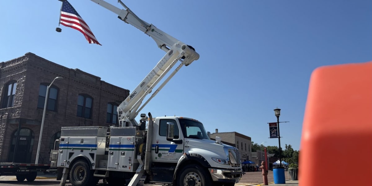 ** Electric utility workers installing new power lines in growing South Dakota suburban community