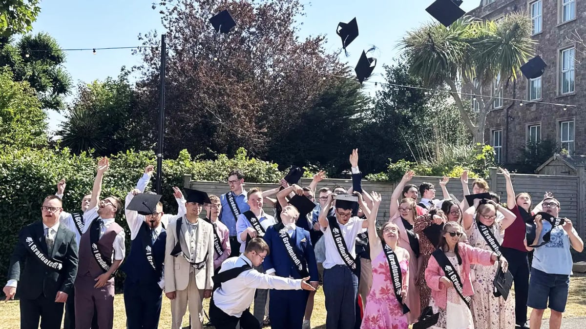 Graduation ceremony with students in caps and gowns celebrating at Butlin's resort venue