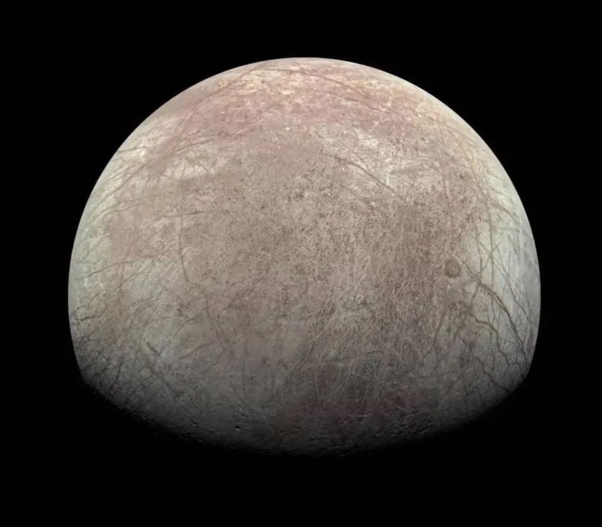 Artist rendering of Jupiter's ice-covered moon Europa with massive ocean beneath frozen surface