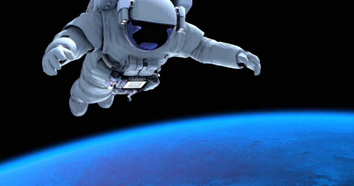 Astronaut Sophie Adenot conducting spacewalk outside International Space Station in white spacesuit