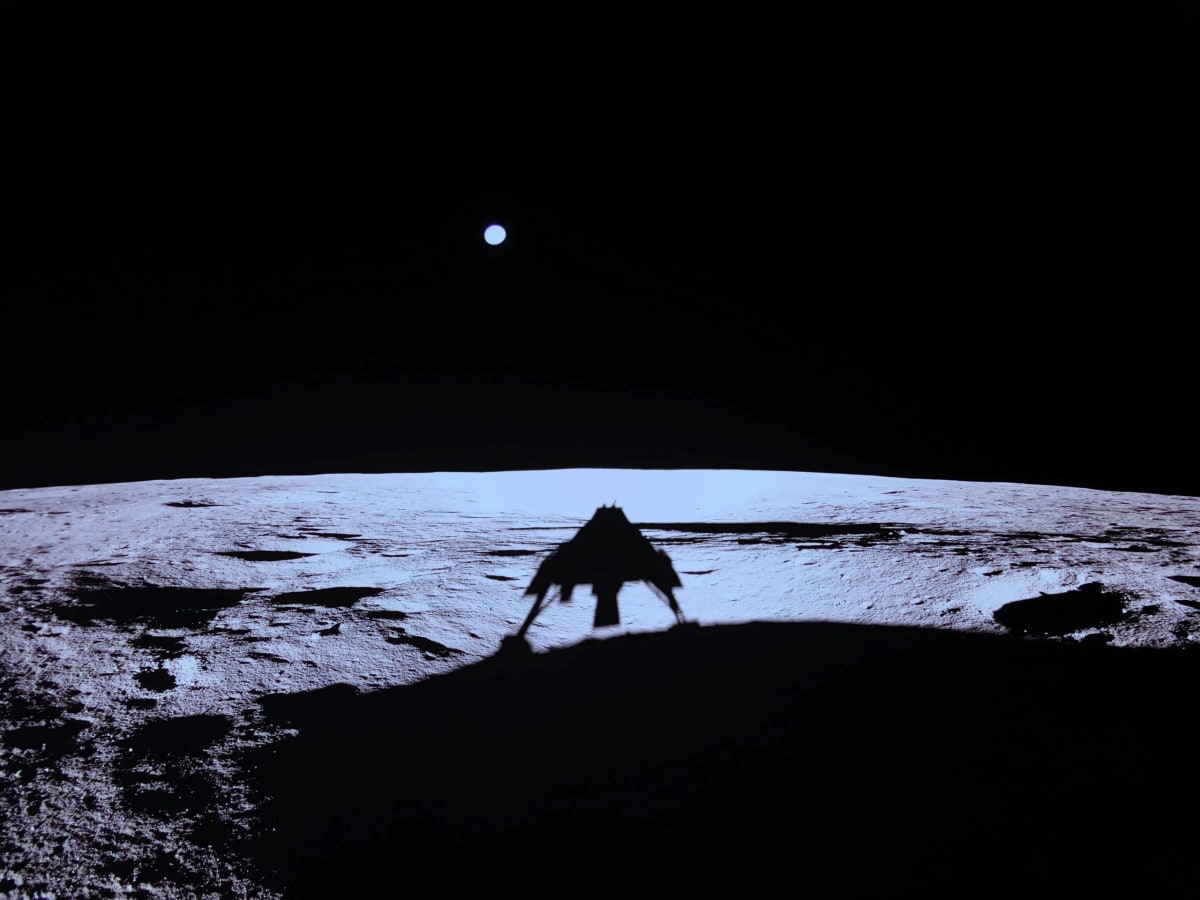 Artist rendering of robotic lunar lander touching down on moon's south pole surface