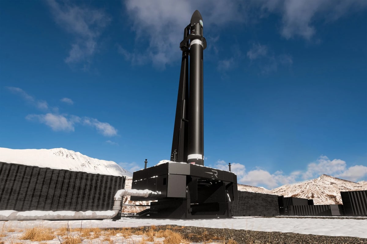 Rocket Lab vehicle on launch pad with Alaskan mountains in background at sunset