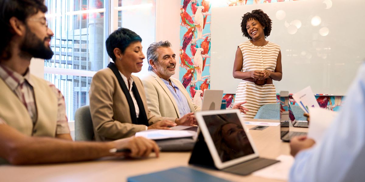 Diverse group of STEM professionals from different generations collaborating together at conference table