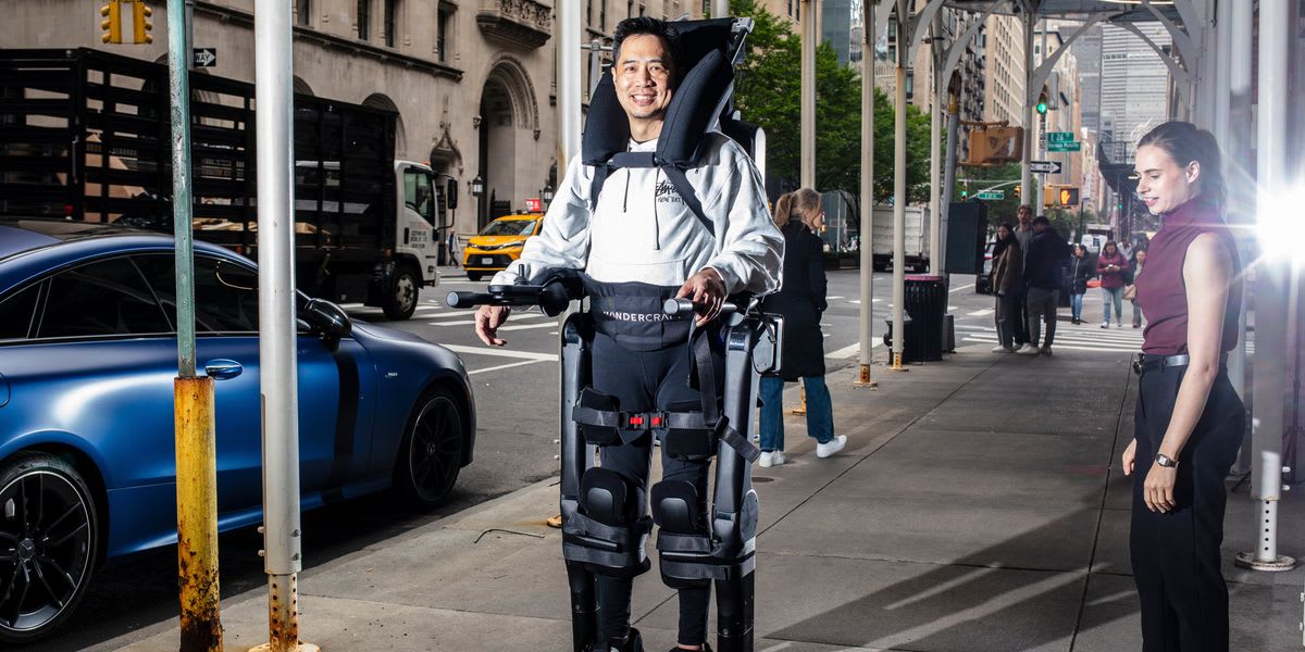 ** Robert Woo standing upright in Wandercraft exoskeleton on New York City street