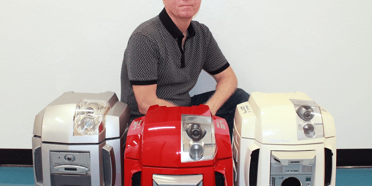 Tom Burick and students assembling wooden base of historic ENIAC computer replica in classroom