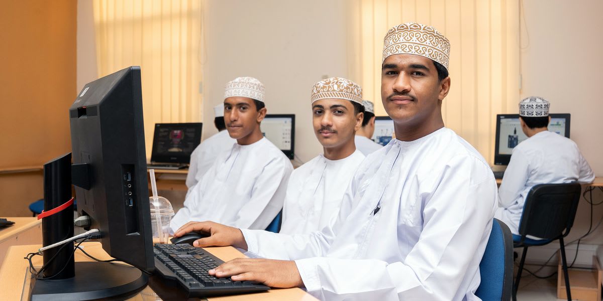 High school students working together on circuit design project at university engineering program