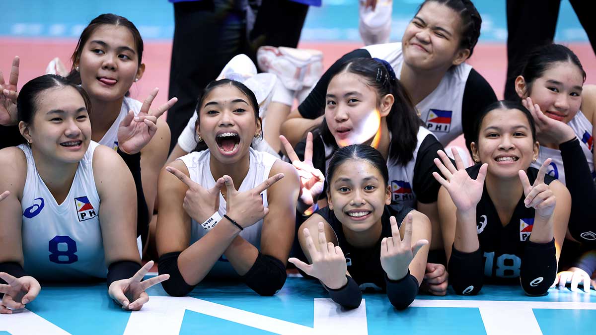 Smiling Filipino teenage volleyball players celebrating together after historic 15th place finish at world championship