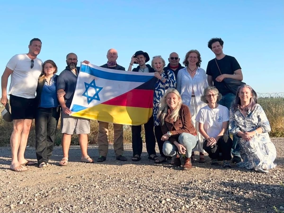 German volunteers working outdoors at Kibbutz Nir Oz rebuilding site in Israel