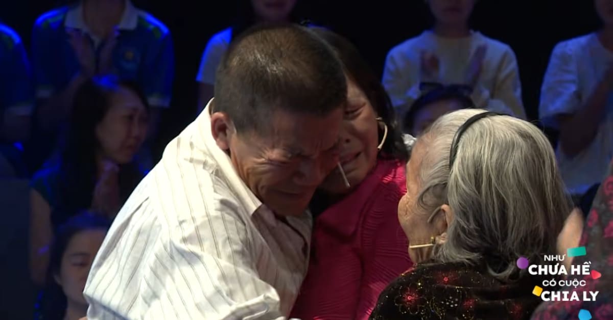 Elderly Vietnamese woman embracing younger woman during emotional family reunion after 50 years apart