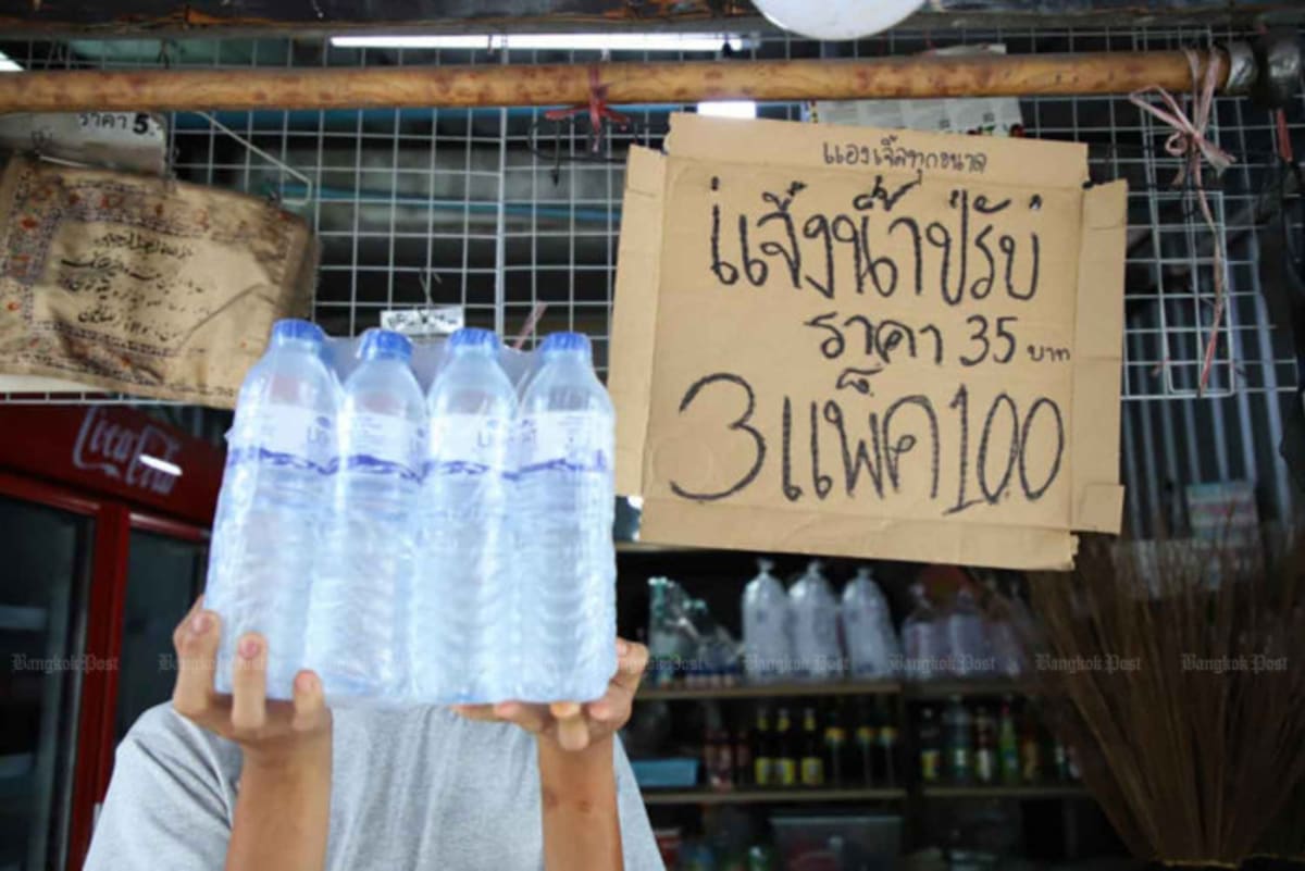 Stacks of bottled water packages at Bangkok wholesale shop illustrating plastic supply concerns