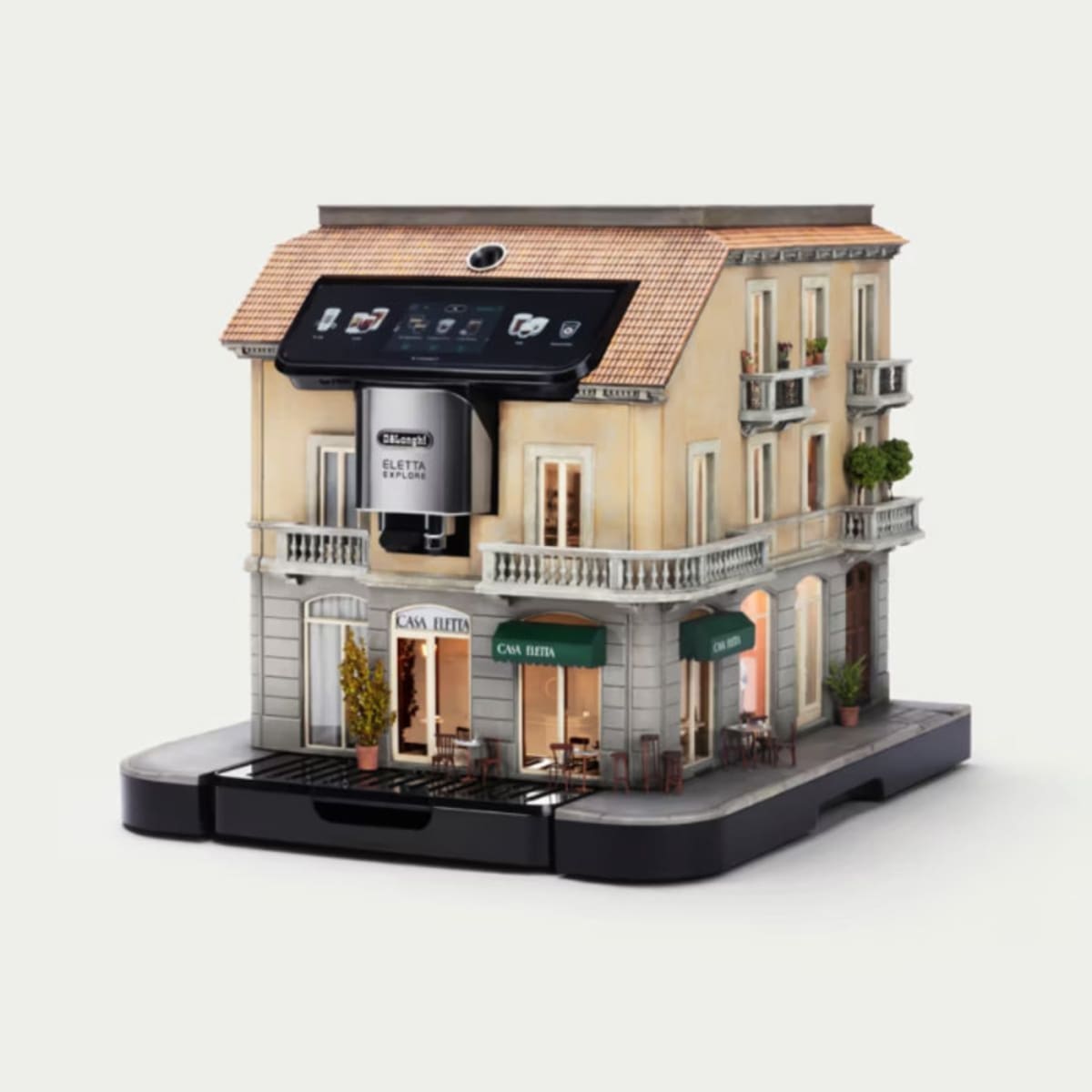 Miniature coffee shop facade built into De'Longhi espresso machine with intricate architectural details