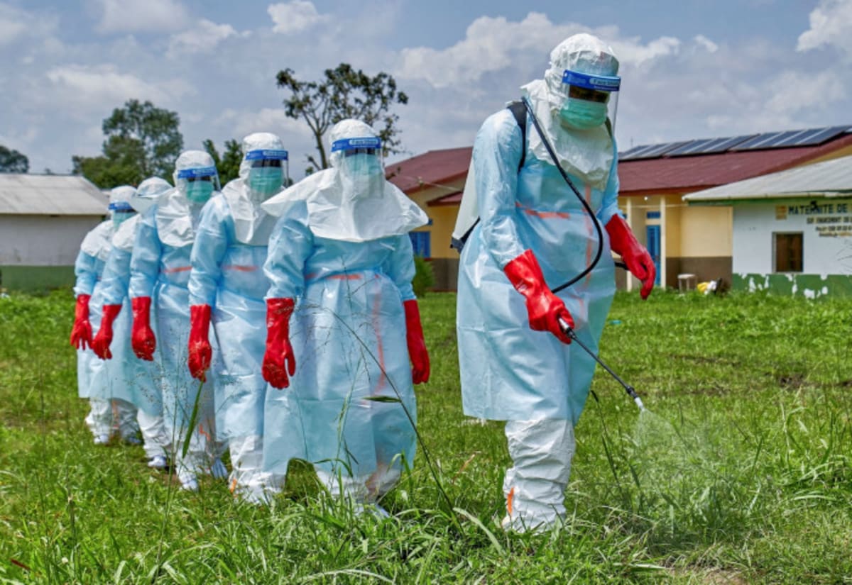 Health workers in protective gear conducting screening procedures at Thailand airport terminal