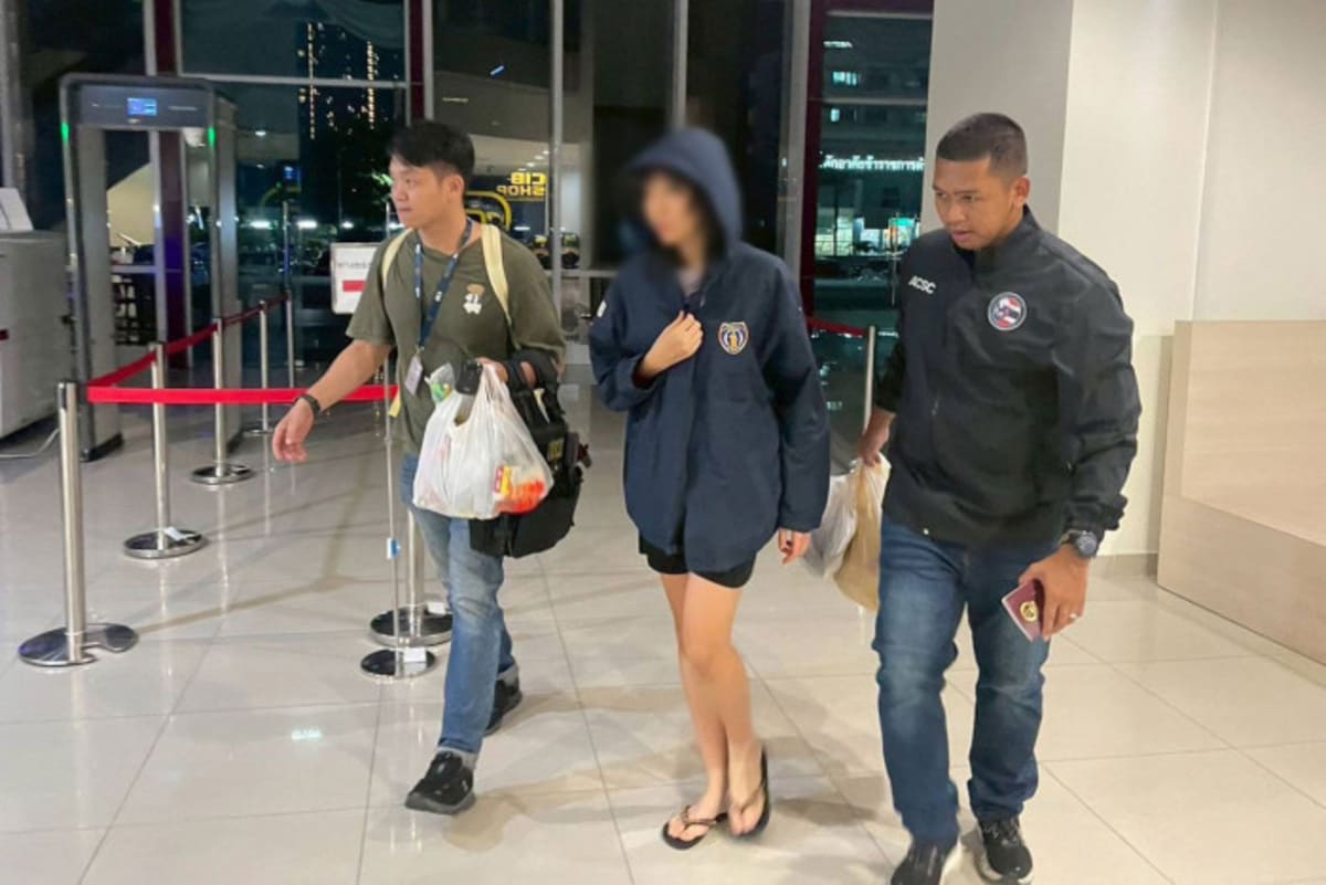 Thai police officers escort rescued Chinese student from hotel in Samut Prakan province