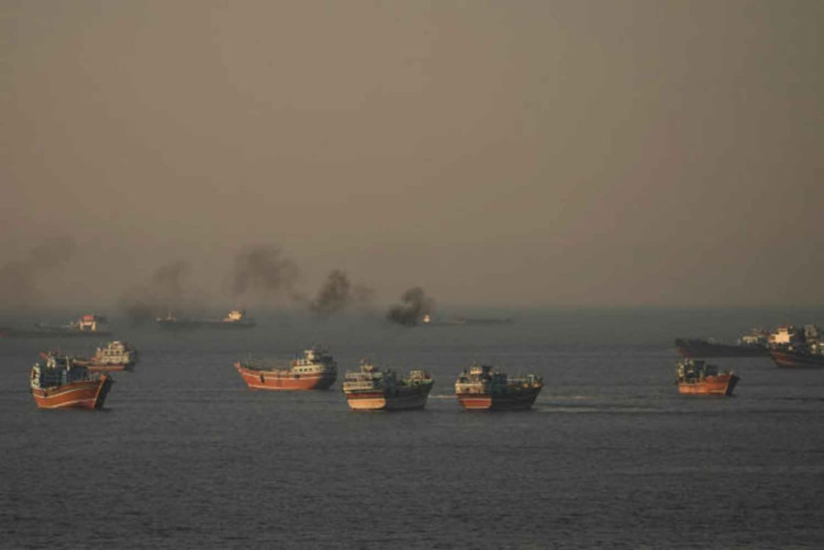 Commercial vessels sailing through the Strait of Hormuz near Musandam, Oman
