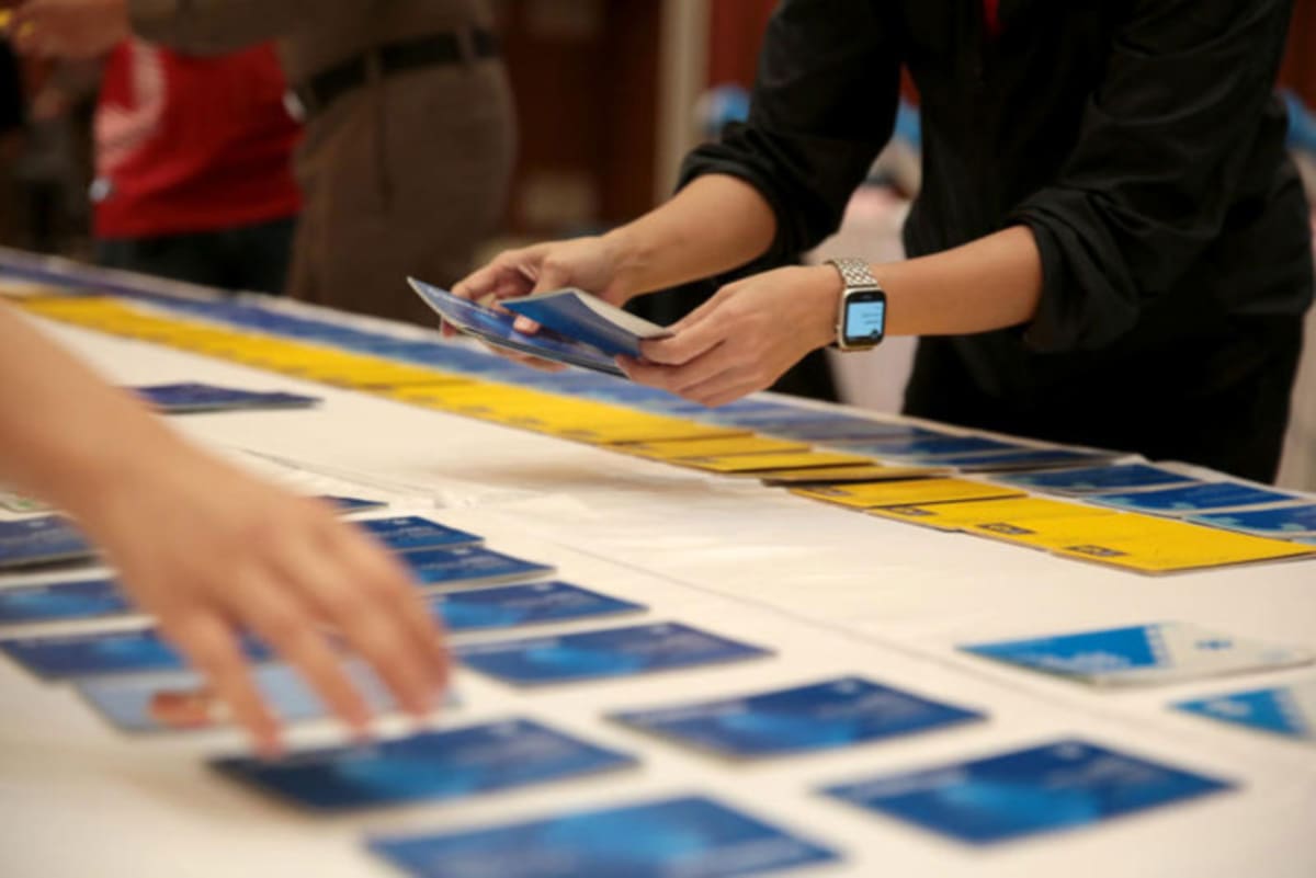 Bank officials displaying seized passbook accounts during fraud prevention media briefing in Thailand