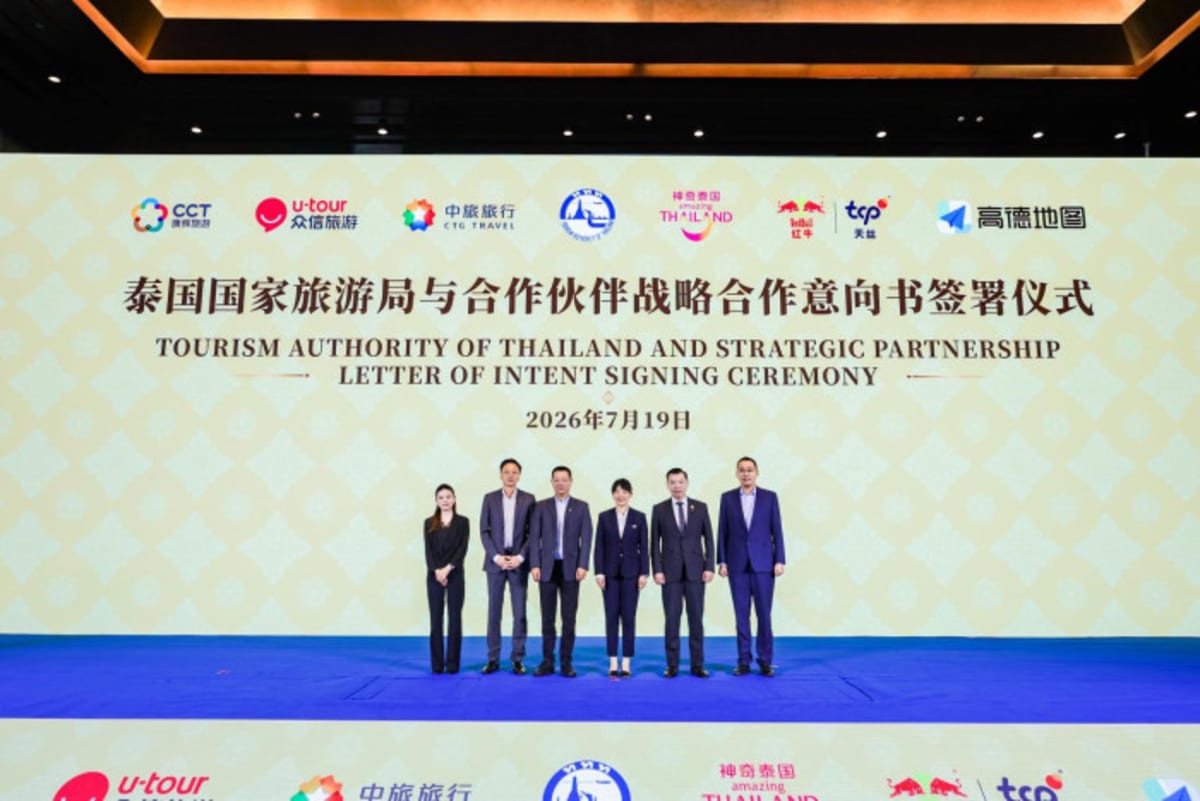 Thai tourism officials and Chinese business partners shaking hands at partnership signing ceremony in Bangkok