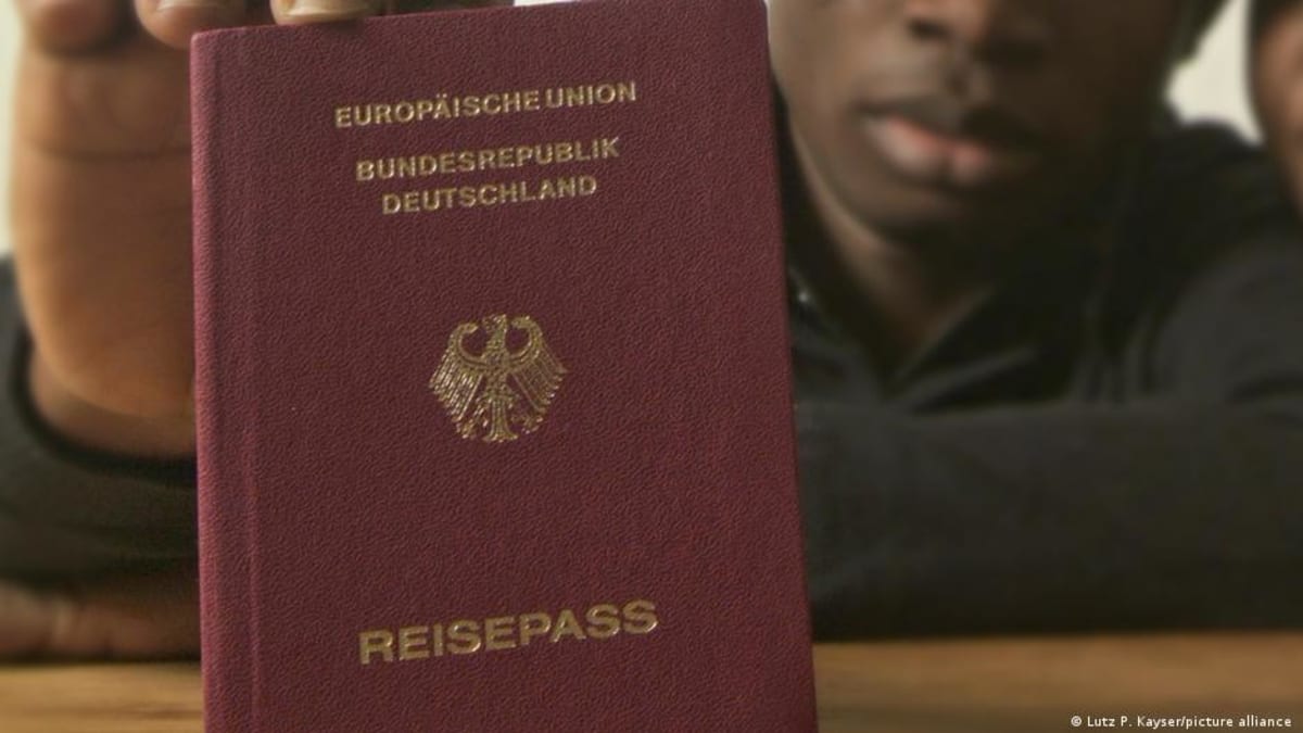 Hands holding a German passport, symbolizing new citizenship and belonging in Germany
