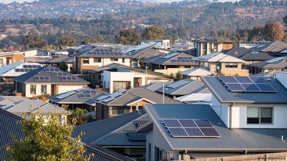 Solar panels covering residential rooftops across Australian suburban neighborhood on sunny day