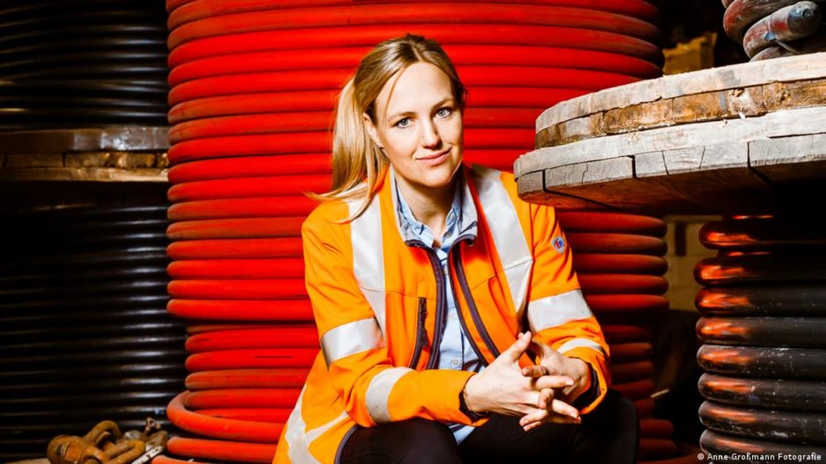 Woman wearing bright orange high-visibility protective workwear designed specifically for female body proportions