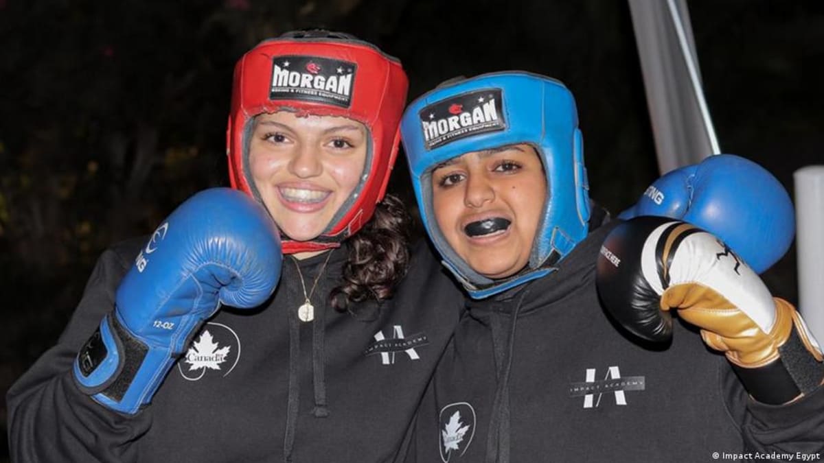 Young Egyptian girls in boxing gloves training at Impact Academy in Cairo