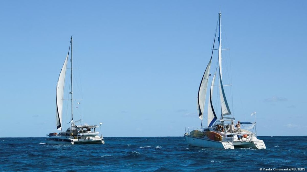 Mexican Navy vessel escorting humanitarian aid sailboats through ocean waters toward Cuba