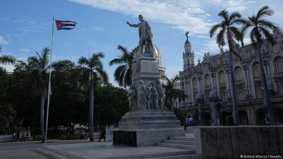 ** Cuban flag waving against blue sky symbolizing renewed hope and freedom