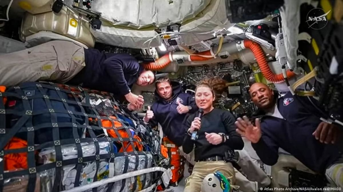 ** Orion space capsule in orbit above Earth during historic distance record mission