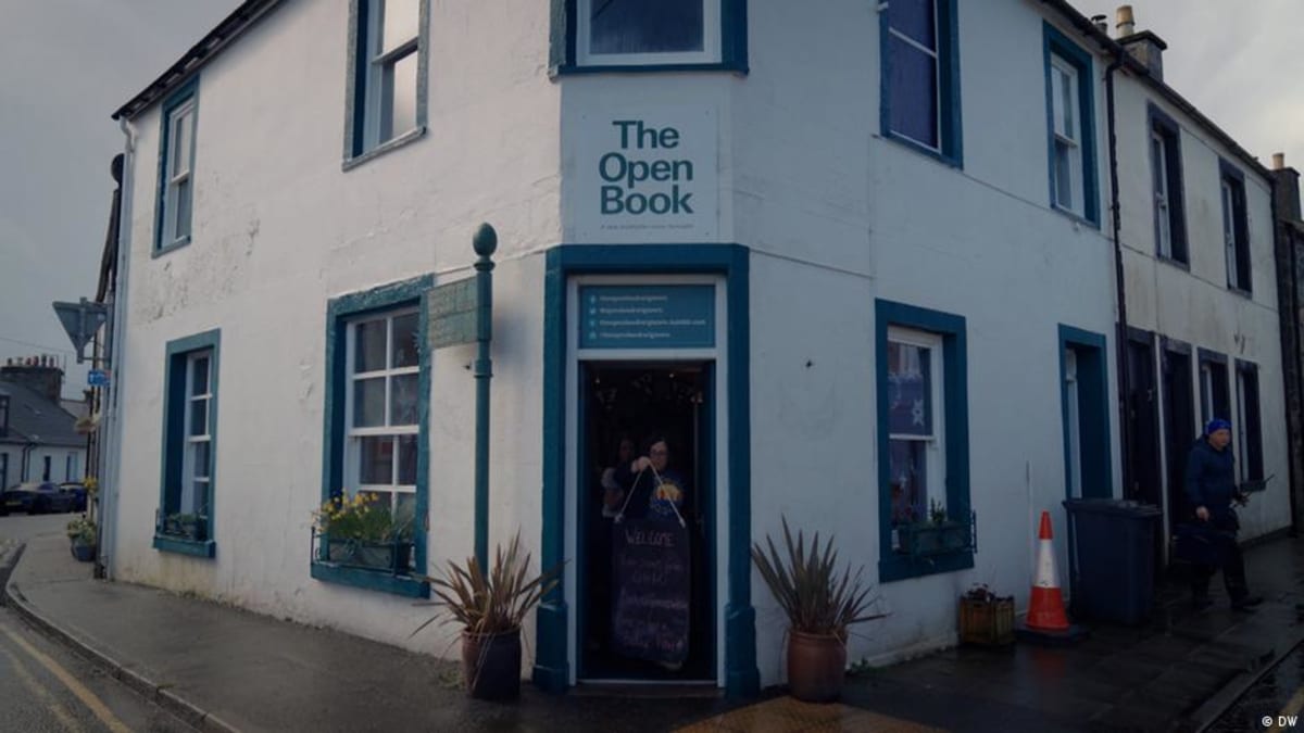 The Open Book storefront in Wigtown, Scotland, a cozy bookshop with upstairs rental apartment