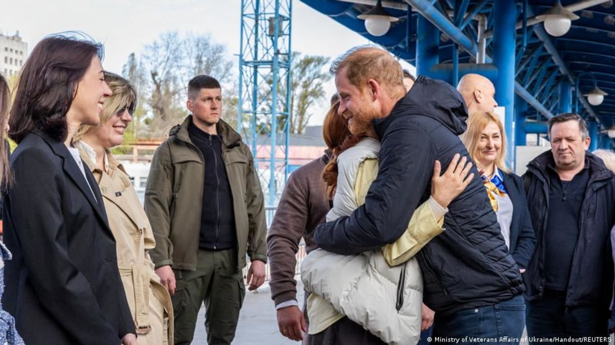 Prince Harry greeting people on train platform after arriving in Kyiv, Ukraine