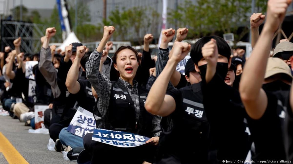 Samsung semiconductor manufacturing facility in South Korea with workers in clean room suits
