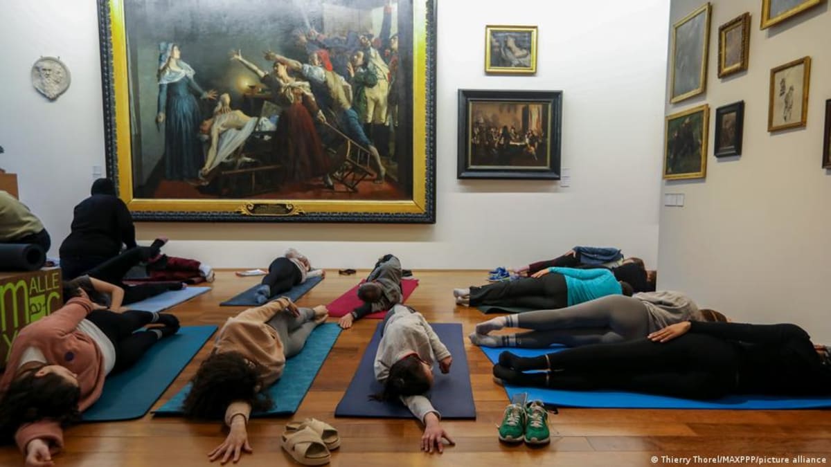 ** Museum visitors participating in interactive community program, breaking traditional gallery viewing norms