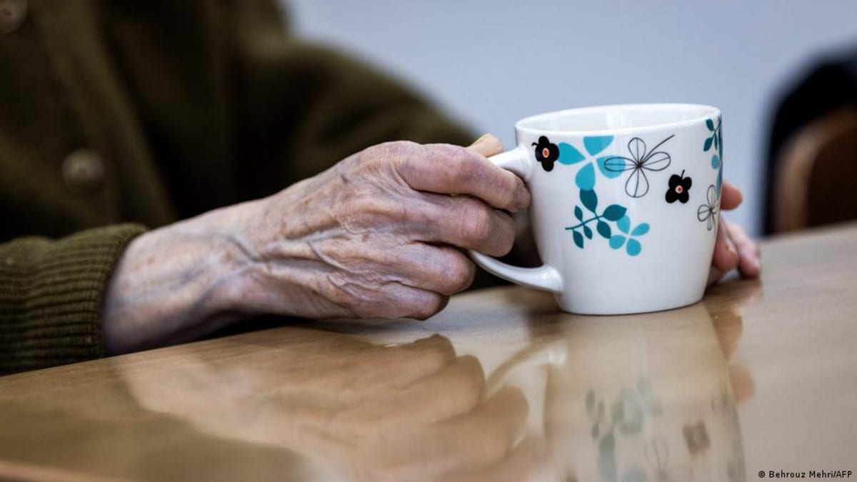 Elderly Japanese residents gathering together at a community café sharing tea and conversation