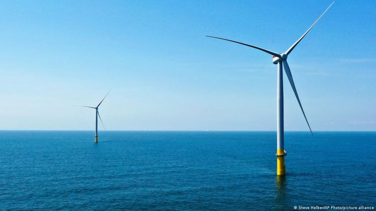 Offshore wind turbines rising from ocean waters generating clean renewable electricity