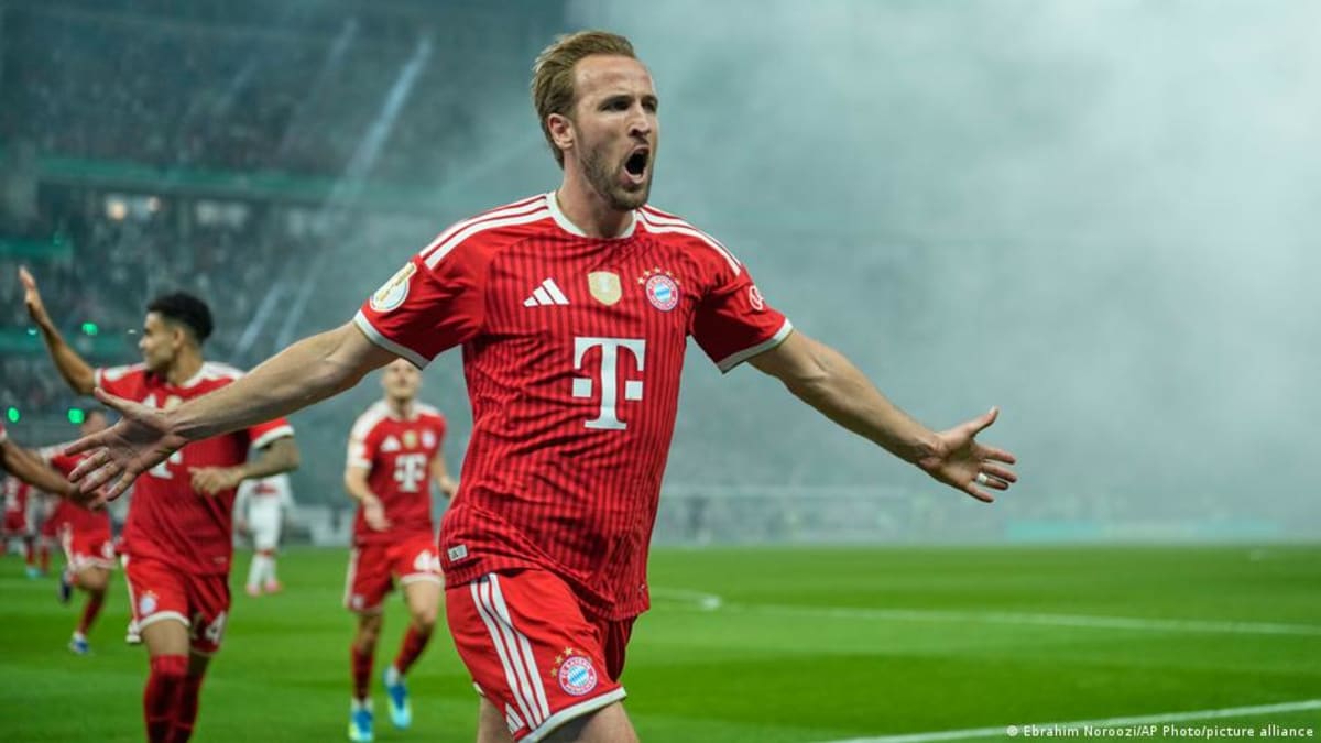 Harry Kane celebrating in Bayern Munich red jersey after scoring hat trick in German Cup final