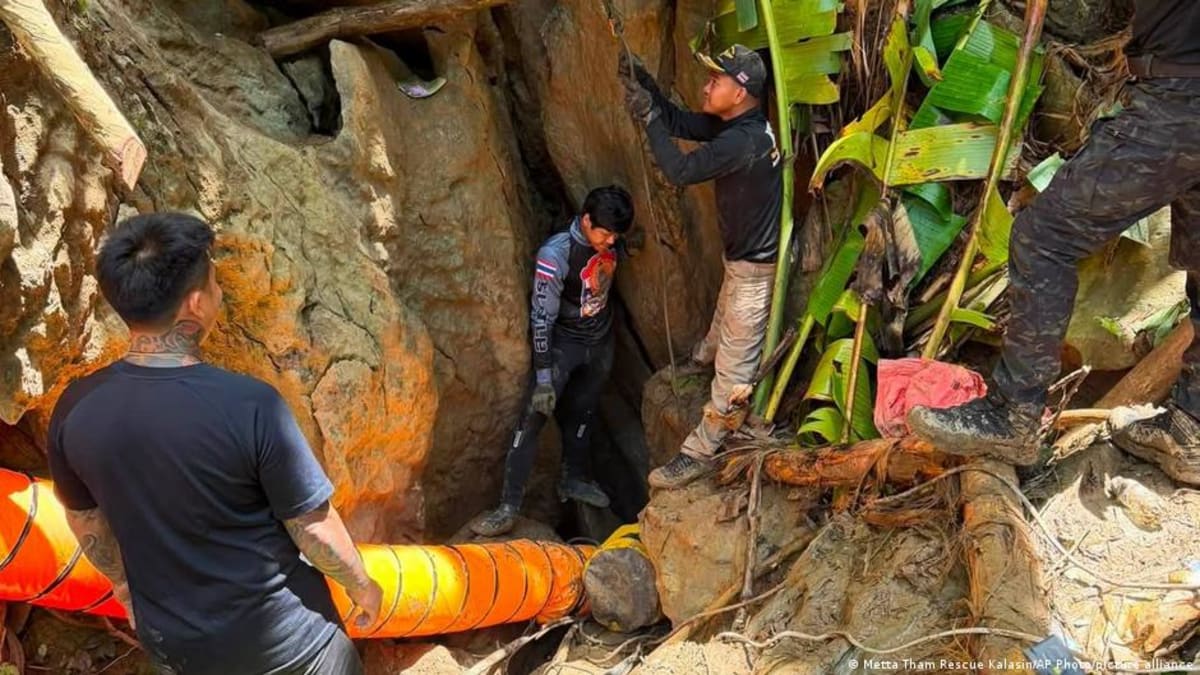 Rescue team members celebrating inside cave after finding five people alive in Laos